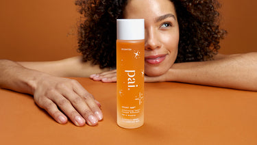 Close up of model holding Pai Skincare Bright Now exfoliating toner for sensitive skin