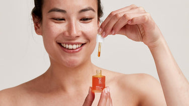 woman smelling rosehip oil